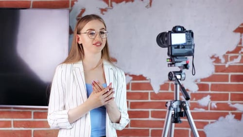 Charming Young Blogger Girl Working at Media Production Studio in Front of Professional Equipment