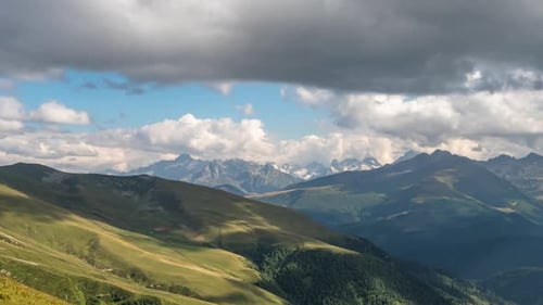 Expansive Mountain Range with Rolling Clouds