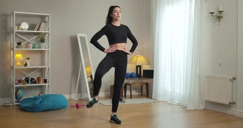 Young Woman Doing High Knees in Living Room