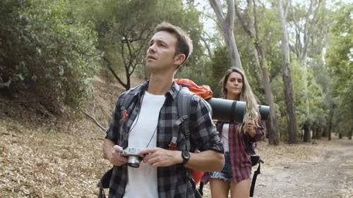 Couple of Hikers with Photo Camera Taking Pictures of Landscape