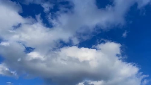 Clouds Moving Across a Bright Blue Sky