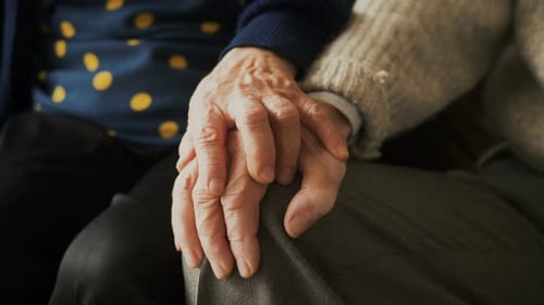 Senior Couple Holding Hands in Loving Support