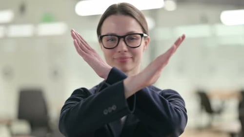 Portrait of Young Businesswoman showing No Sign by Arm Gesture
