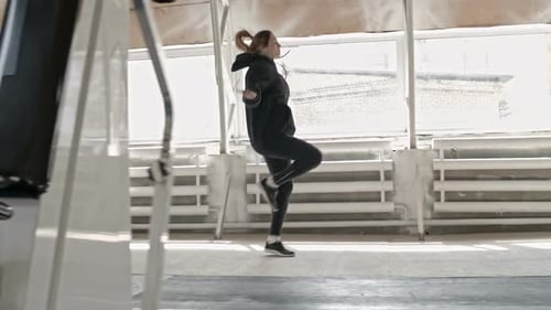 Fit Woman Jumping Rope in Bright Indoor Gym