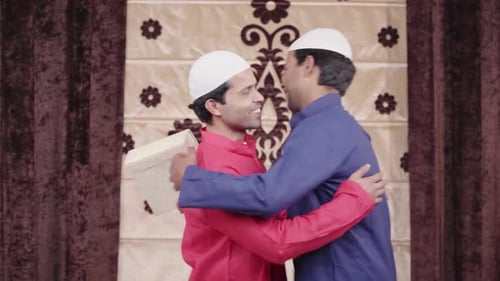 Muslim men giving sweet box on Eid