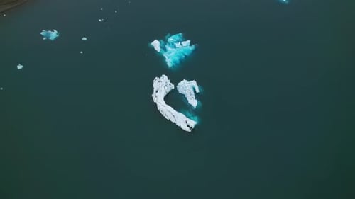Drone Shot of Iceberg Slowly Melting on Top On Endless Horizon of Ocean Waters