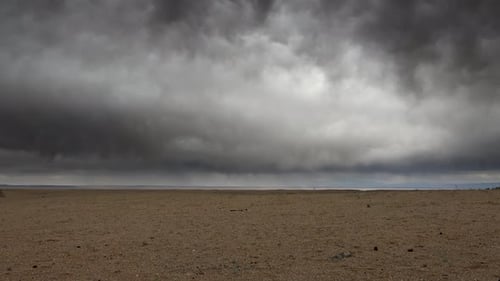 Dark Storm Clouds Over The Vast Arid Desert