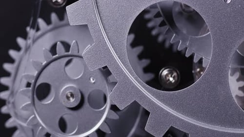 Rotating Silver Cogwheels in a Machine Close Up