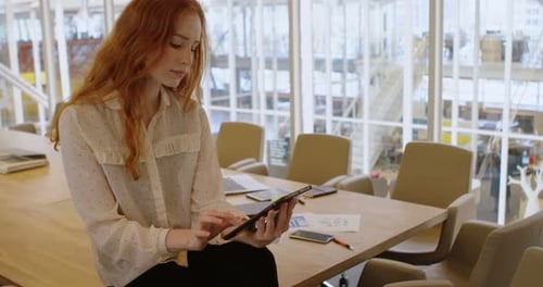 Female executive using digital tablet in office 4k