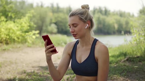 Woman Video Chatting Outdoors After Exercise
