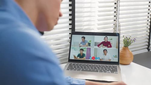 Asian businessman use laptop computer video call with office colleague.