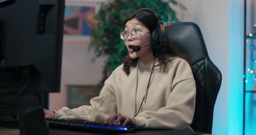 Woman Enthusiastically Plays Video Game on Computer