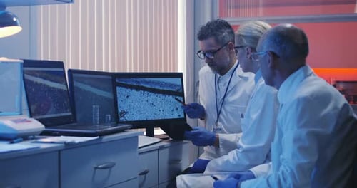 Scientists Watching Monitor and Analyzing