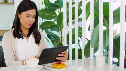 Asian Woman with Tablet Pc at Cafe or Coffee Shop