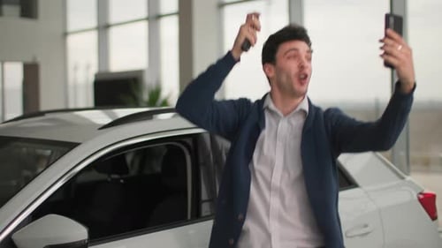 Excited Man Holding Car Keys, Celebrating New Purchase