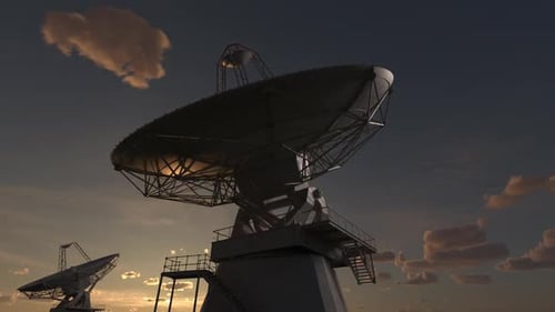 Large Satellite Dishes Scanning the Sky at Sunset