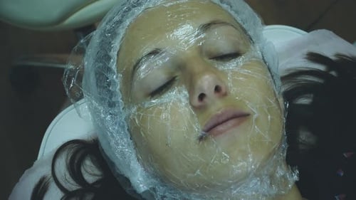 Adult Receives Facial Treatment in Clinic