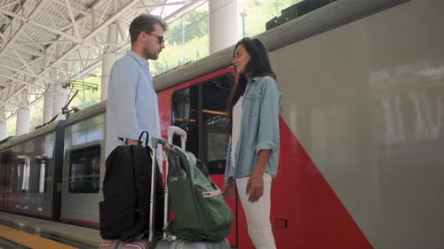 Two Passengers Are Waiting Boarding To Train on Railway Station