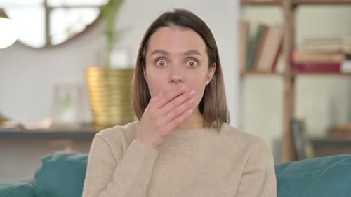 Surprised Woman Covering Her Mouth with Hand