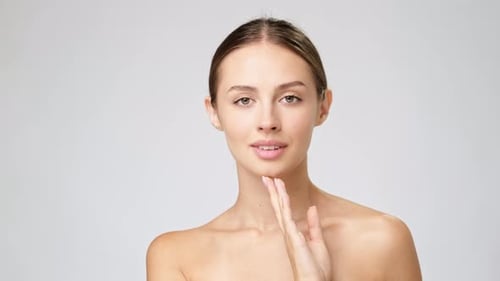 Young Woman Posing and Touching Her Face