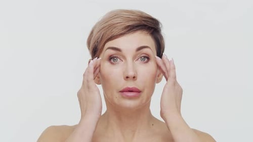 Close-up of middle aged mature woman over white background.