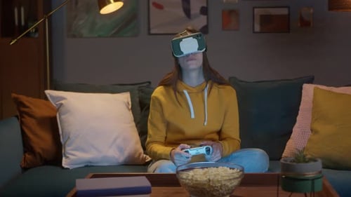 Woman Playing VR Game on Couch at Home