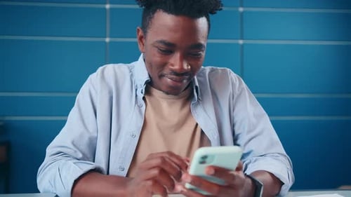 Excited Man Celebrates Good News on Smartphone