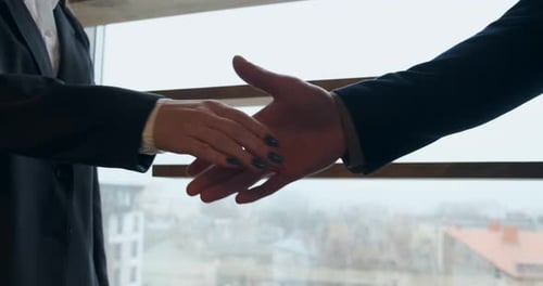 Close Up of Business People Shaking Hands at Successful Corporate Partnership. Male and Female