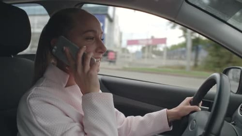 Woman Talking on Mobile Phone while Driving