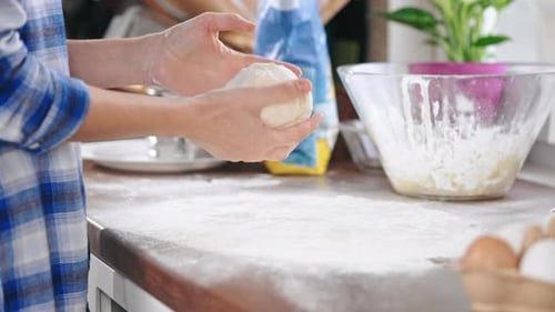 Lady Forming Dough Into a Smooth Ball