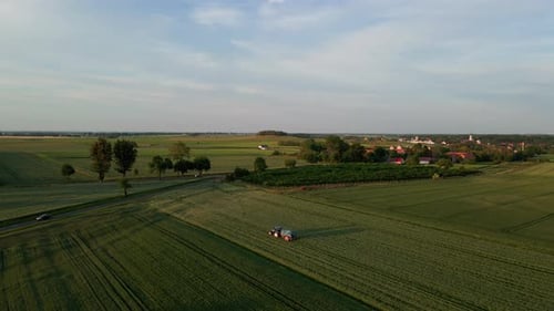 Tractor Spray Fertilizer on Agricultural Field Aerial View