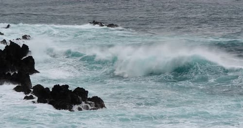 Powerful Waves Crashing Against Rocky Coast