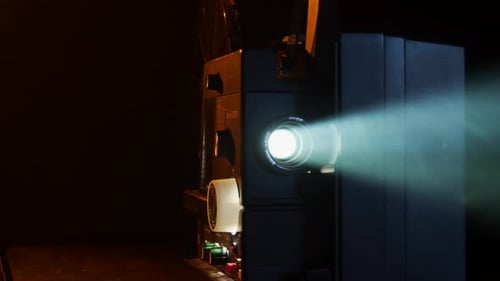 Film Projector with Light Shining in Dark Room