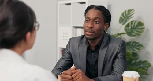 Darkskinned Boss in Suit Talks with Candidate for Position of Office Secretary Job Interview