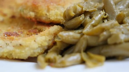 Tilting on fresh green beans and fried fish tasty healthy lunch on plate 1920X1080 FullHD footage -