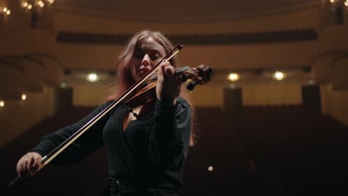 Caucasian Female Violinist is Playing Fiddle in Music Hall Medium Portrait of Musician