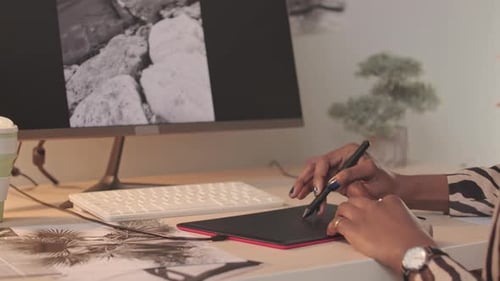 Woman Working on Tablet in Office Setting