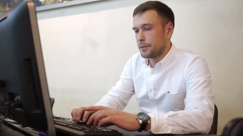 Handsome Businessman Working with Laptop in Office