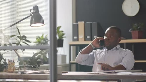 Afro-American Businessman Having Phone Talk in Office