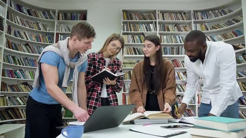 Diverse Students Studying Together in Library Achieving Success