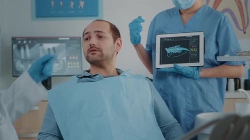 Health Professionals Explaining Dental X-Ray to Patient