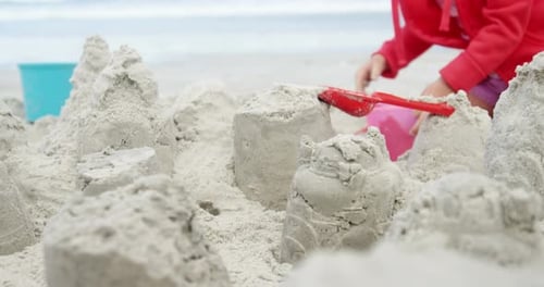 Girl making making sand castle at beach