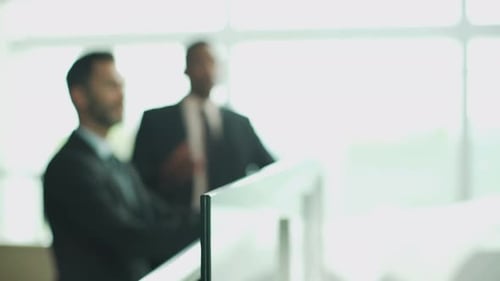 Business professionals looking at office building interior