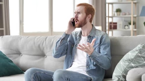 Upset Man Talking on Phone in Interior Setting