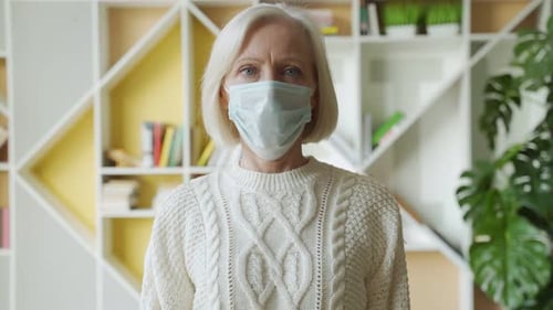 Adult Woman Adjusting Her Medical Mask Indoors