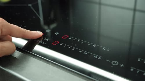 Finger Adjusting Settings on Induction Stove Top