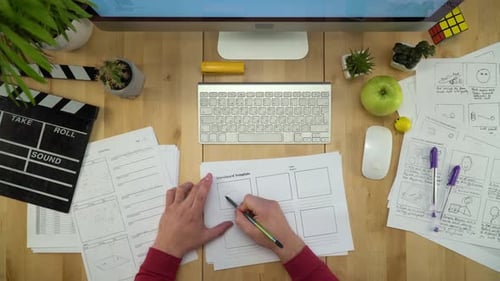 Storyboard Artist Drawing Film Shots at Wooden Desk