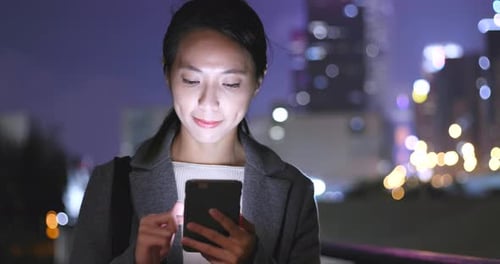 Woman use of mobile phone in city