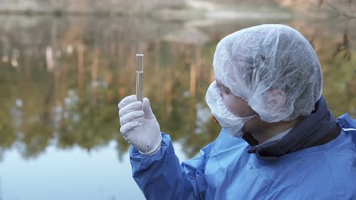 The Ecologist Checks the Water From the River for Infections, Harmful Emissions
