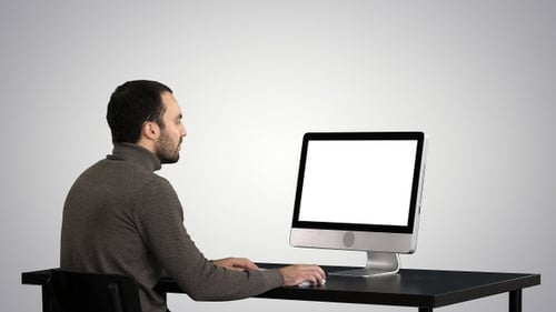 Mann tippt am Computer auf Hintergrund mit Farbverlauf